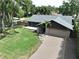 This single-Gathering home features a new roof, manicured lawn, and an attached two car garage at 11525 Country Oaks Dr, Tampa, FL 33618