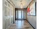 A wide foyer featuring wood flooring, neutral walls and a modern chandelier at 11525 Country Oaks Dr, Tampa, FL 33618