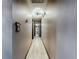 Hallway featuring wood-look floors and bright lighting at 11525 Country Oaks Dr, Tampa, FL 33618