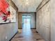 Elegant hallway features wood floors, decorative artwork, a chandelier, and closet space at 11525 Country Oaks Dr, Tampa, FL 33618