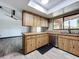Kitchen featuring wood cabinets, stainless steel appliances, and a view of the living area at 11525 Country Oaks Dr, Tampa, FL 33618