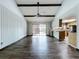 Spacious living room with wood floors, beamed ceilings, and sliding glass doors to the outdoor space at 11525 Country Oaks Dr, Tampa, FL 33618