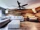 Spacious living room with a wood accent wall, comfortable seating, and modern lighting at 11525 Country Oaks Dr, Tampa, FL 33618