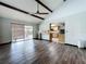 Bright living room with wood floors, vaulted ceiling, and sliding glass doors to the outdoor space at 11525 Country Oaks Dr, Tampa, FL 33618
