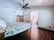 Comfortable main bedroom boasts a ceiling fan and leads to a bright, remodeled bathroom with a tub at 11525 Country Oaks Dr, Tampa, FL 33618