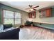 A home office featuring a desk with custom cabinets and modern ceiling fan at 11525 Country Oaks Dr, Tampa, FL 33618