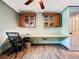 Bright home office with hard surface floors, custom desk and wood cabinets at 11525 Country Oaks Dr, Tampa, FL 33618
