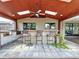 Covered outdoor kitchen featuring a grill, bar seating, and tile flooring, perfect for entertaining at 11525 Country Oaks Dr, Tampa, FL 33618