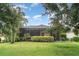 The home boasts a screen patio, lush greenery and large yard perfect for outdoor activities and relaxation at 11849 Forest Park Cir, Bradenton, FL 34211
