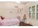 Adorable bedroom with natural light, hardwood floors, and a four poster canopy bed at 11849 Forest Park Cir, Bradenton, FL 34211