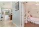 Open hallway showcases a bedroom and flows into the living area with ample natural light at 11849 Forest Park Cir, Bradenton, FL 34211