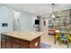 Kitchen island with granite counters overlooks the open-concept living area and dining space at 11849 Forest Park Cir, Bradenton, FL 34211
