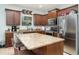Well-equipped kitchen featuring granite countertops, stainless steel appliances, and dark wood cabinets at 11849 Forest Park Cir, Bradenton, FL 34211