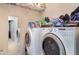 Functional laundry room with modern appliances, storage shelving, and tile flooring at 11849 Forest Park Cir, Bradenton, FL 34211