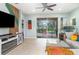 Bright living room with tile floors, sliding glass doors and a decorative wall unit at 11849 Forest Park Cir, Bradenton, FL 34211