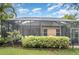 The home features an enclosed screen patio with greenery, enhancing outdoor privacy and relaxation at 11849 Forest Park Cir, Bradenton, FL 34211