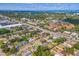 Scenic aerial view of the neighborhood, featuring mature trees, and various community amenities at 1220 Magnolia Dr, Clearwater, FL 33756