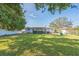 Beautifully maintained backyard with lush green grass and mature trees, providing a serene outdoor space at 1220 Magnolia Dr, Clearwater, FL 33756