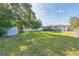 The backyard is spacious with trees and a storage building, perfect for outdoor activities and storage needs at 1220 Magnolia Dr, Clearwater, FL 33756