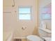 Clean and simple bathroom with a white toilet, shower, neutral walls, and bright natural light at 1220 Magnolia Dr, Clearwater, FL 33756
