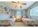 Inviting bedroom with twin beds, stylish decor, and ample natural light, perfect for guests or children at 1220 Magnolia Dr, Clearwater, FL 33756