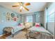 Bright and cheerful bedroom features twin beds, eclectic wall decor, and a comfortable atmosphere for restful nights at 1220 Magnolia Dr, Clearwater, FL 33756