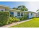 Inviting facade with tidy landscaping, brick accents, and a light-blue front door at 1220 Magnolia Dr, Clearwater, FL 33756