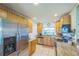 Bright kitchen featuring stainless steel appliances, and light wood cabinets at 1220 Magnolia Dr, Clearwater, FL 33756