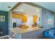 Kitchen with breakfast bar, stainless steel appliances, and light wood cabinets at 1220 Magnolia Dr, Clearwater, FL 33756