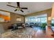 Comfortable living area with sliding glass doors leading to a sunroom, and an open flow to the kitchen at 1220 Magnolia Dr, Clearwater, FL 33756