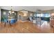 Open-concept layout with hardwood floors, modern furnishings, and seamless flow between dining and living spaces at 1220 Magnolia Dr, Clearwater, FL 33756