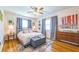 Cozy main bedroom features hardwood floors, a comfortable bed, and a stylish decor with ample natural light at 1220 Magnolia Dr, Clearwater, FL 33756