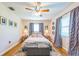 Comfortable main bedroom with hardwood floors, soft lighting, and tasteful decor, perfect for relaxation at 1220 Magnolia Dr, Clearwater, FL 33756