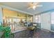 Spacious sunroom with geometric tiled floor, ceiling fan, with a large window view of the home's interior at 1220 Magnolia Dr, Clearwater, FL 33756