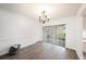 Open dining area features wood-look floors, neutral walls, and a modern chandelier at 13013 Sawmill Way, Hudson, FL 34667