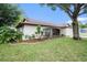 Charming single-story home with a well-manicured lawn and mature trees at 13013 Sawmill Way, Hudson, FL 34667