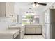 Spacious kitchen features a stainless steel refrigerator and tile flooring at 13013 Sawmill Way, Hudson, FL 34667