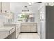 Bright kitchen with white cabinets and modern appliances at 13013 Sawmill Way, Hudson, FL 34667