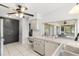 Bright kitchen with ceiling fan, and a gray brick accent wall at 13013 Sawmill Way, Hudson, FL 34667