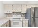 Kitchen features stainless steel appliances and mosaic backsplash at 13013 Sawmill Way, Hudson, FL 34667