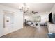 Bright living room boasts wood floors, ceiling fan, and plenty of natural light at 13013 Sawmill Way, Hudson, FL 34667