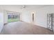 Carpeted living room with sliding glass doors leading to the backyard at 13013 Sawmill Way, Hudson, FL 34667