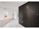 Living room featuring a painted brick wall and access to the bathroom at 13013 Sawmill Way, Hudson, FL 34667