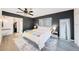 Main bedroom suite with ceiling fan, walk-in closet, and stylish decor at 13013 Sawmill Way, Hudson, FL 34667