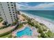 Aerial view of the building and community featuring a pool and beach access at 15000 Gulf Blvd # 901, Madeira Beach, FL 33708