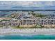 Stunning aerial view of a beachfront condo complex with a wide sandy beach and sparkling turquoise waters at 15000 Gulf Blvd # 901, Madeira Beach, FL 33708