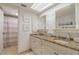 Bathroom featuring double sinks, granite countertops, and a decorative mirror at 15000 Gulf Blvd # 901, Madeira Beach, FL 33708