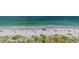 Beach aerial view with clear water, white sand, and lush greenery at 15000 Gulf Blvd # 901, Madeira Beach, FL 33708