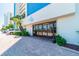 Condo building entrance with large glass doors, landscaping, and convenient parking at 15000 Gulf Blvd # 901, Madeira Beach, FL 33708