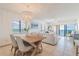 Bright living room featuring a modern chandelier, comfortable seating, and ocean views at 15000 Gulf Blvd # 901, Madeira Beach, FL 33708